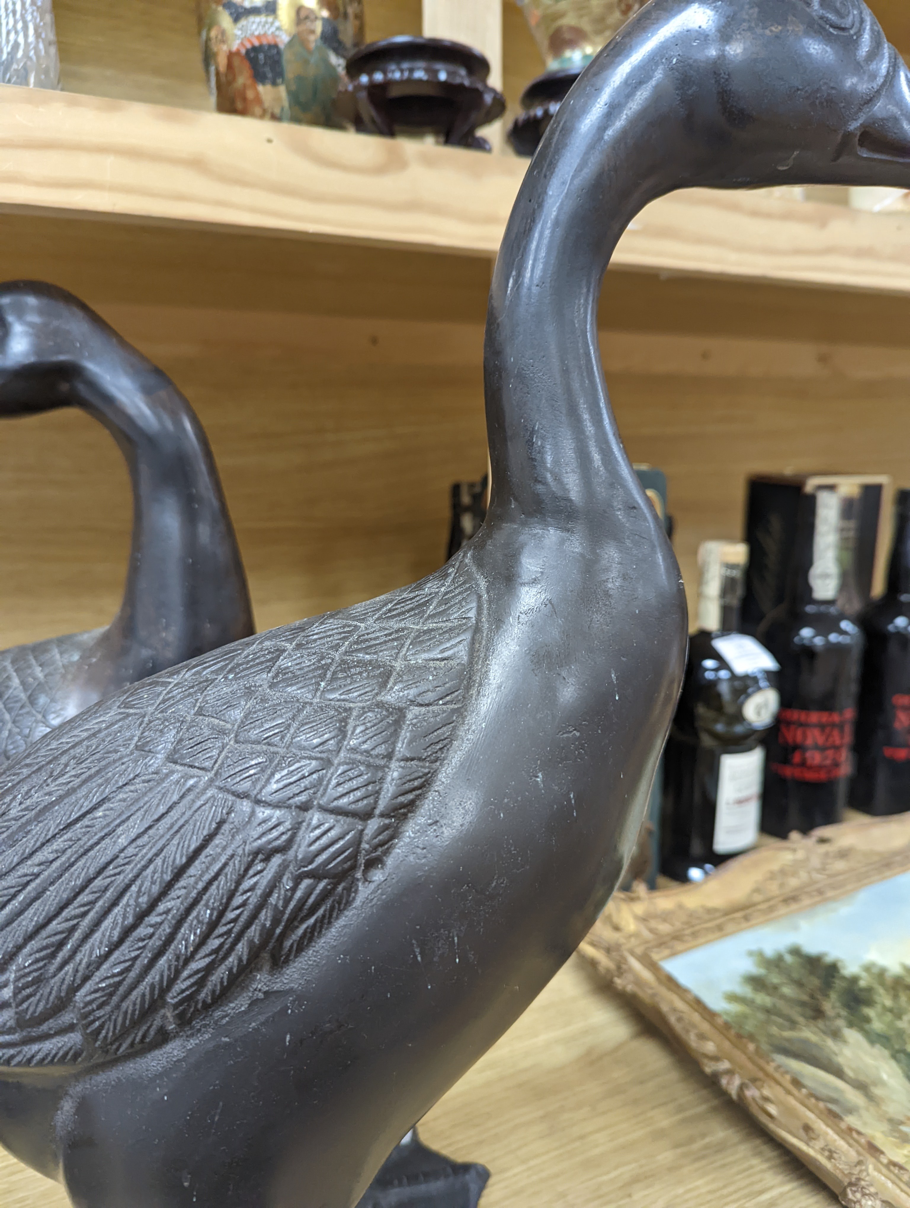 A pair of modern Chinese bronze models of geese, largest 48cm